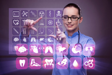 Woman doctor pressing buttons with various medical icons