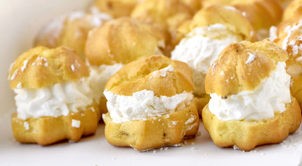 Cream puff cakes with whipped cream in white box