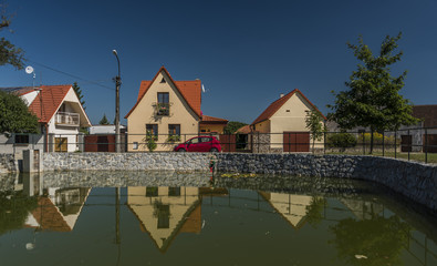 Fototapeta na wymiar Branisov village with pond and houses