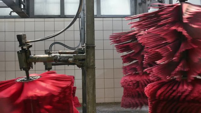 Spinning car wash brushes turning in anticipation of the next vehicle to run through.