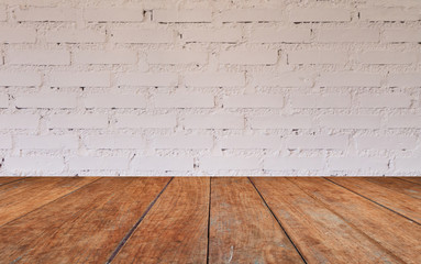 Wooden table top with brick wall