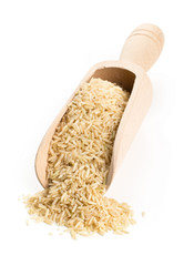 Natural brown uncooked rice in wooden scoop