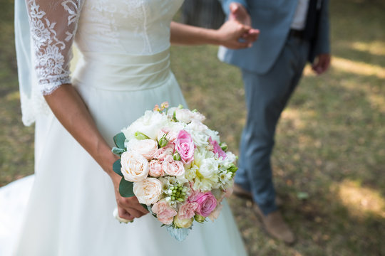 Beautiful wedding bouquet in hands of bride