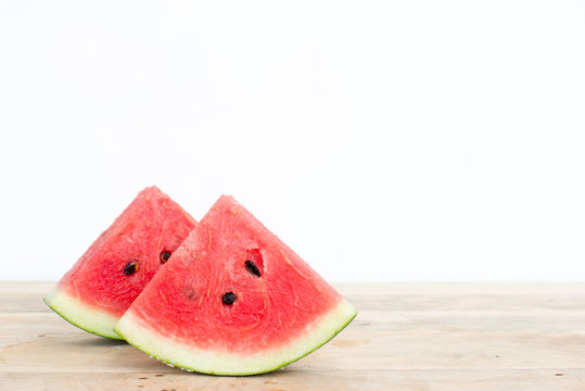 Sliced watermelon on wooden table background.