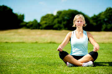 Meditating woman sitting on lotus posture.