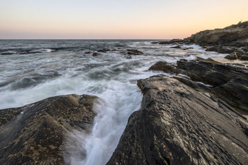 Sunset on a rocky shore.