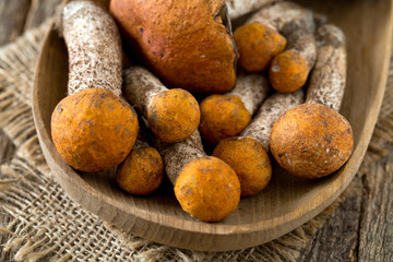 orange-cap boletus on wooden surface