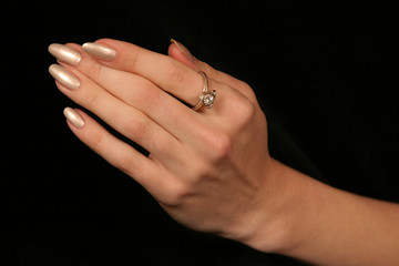 female hand holding fingers diamond ring
