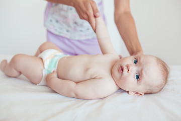 Woman doing exercises and massage the baby