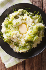 Irish colcannon - mashed potatoes with savoy cabbage closeup. Vertical top view

