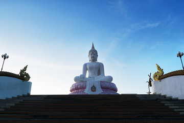 White Buddha on blue sky.