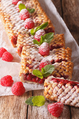 Sliced raspberry pie close-up on the table. Vertical

