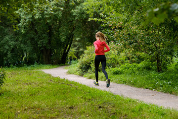 Young slim woman jogging in a park