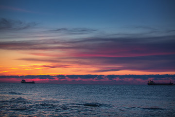 Obraz premium Beautiful cloudscape over the sea, scenic sunrise and boats