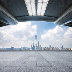 cityscape and skyline of guangzhou from empty brick floor