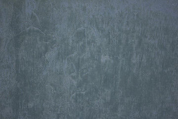 Washed by rain plastered turquoise wall .