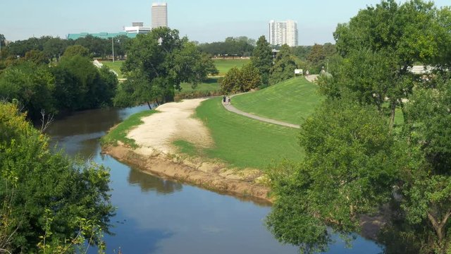 Scene tilts up from a portion of Eleanor Tinsley park to outlying areas of Houston Texas.