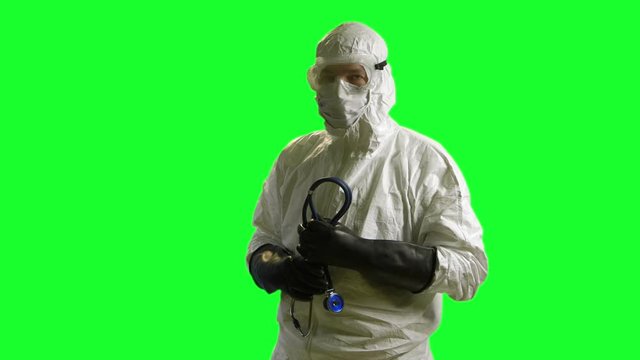 A doctor or nurse wearing full protection against biological exposure such as to the Ebola virus on green screen 
