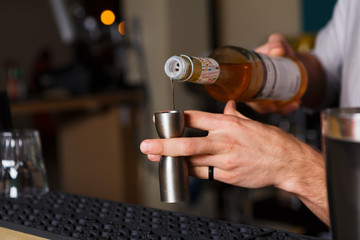 Fototapeta na wymiar Barman's hands making shot cocktail