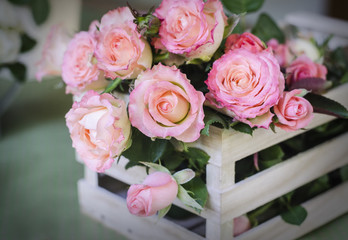 Beautiful pink roses in a wooden box