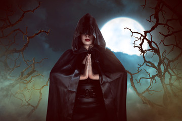 Asian witch woman casting spell in the night