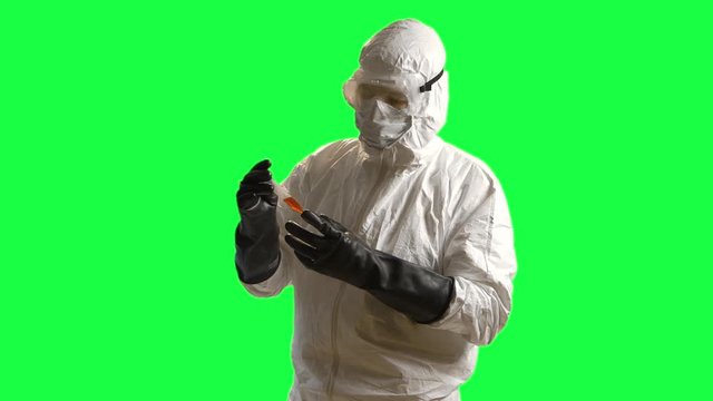 green screen of a doctor in hazmat gear looking at a blood sample