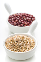two porcelain bowls with sesame seeds and azuki isolated