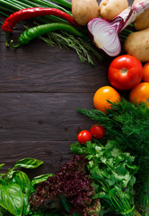 Border of fresh vegetables on wooden background with copy space