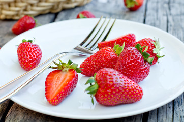 Ripe red strawberries on wooden table