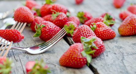 Strawberry and cutlery on a wooden table
