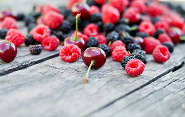 mulberry and raspberry fruit on a wooden table