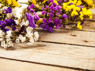 Flowers on wooden background as background