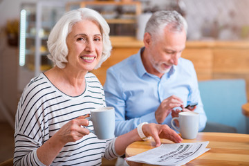 Joyful woman resting in the cafe with her husband.