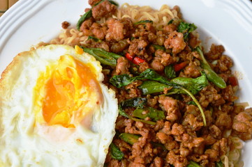 instant noodle topping spicy stir fried chop pork and basil leaf with egg