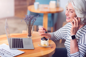 Cheerful woman talking on cell phone