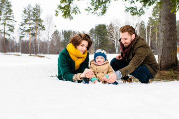 Fototapeta na wymiar happy family against the background of snow