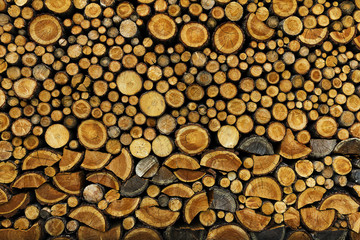 BACKGROUND OF DRY CHOPPED FIRE WOOD LOGS IN A PILE