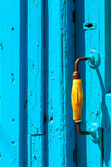 Blue wooden door and yellow handle