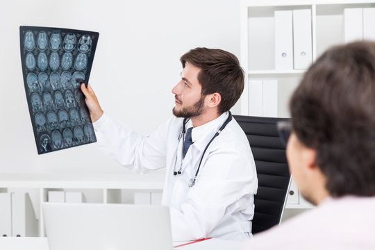 Doc looking at x ray image