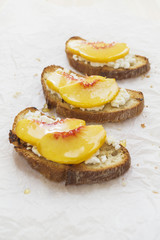 Fresh peach crostini with honey and ricotta cheese