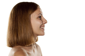 Naklejka premium profile of smiling young beautiful woman without makeup