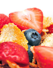 Breakfast bowl with fresh fruits and corn flakes. Close up.
