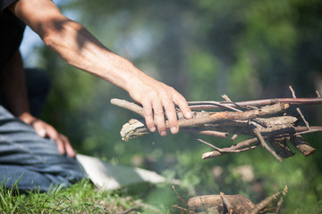 Man setting fire in forest by matches