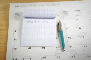 Naklejka na ściany i meble A desk top with notebook, pen and calendar