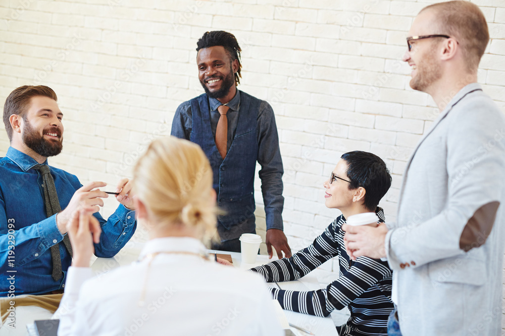 Poster group of young business men and women meeting in office, talking and telling stories and jokes at co