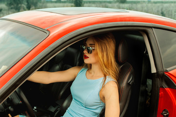Fototapeta na wymiar young beautiful woman in car