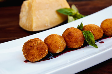 Cheese croquettes (Cheese breaded Camembert with berry sauce)