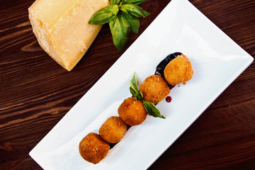 Cheese croquettes (Cheese breaded Camembert with berry sauce)