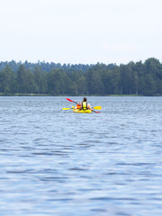 Fototapeta na wymiar Canoeing in the lake on a cloudy day.