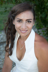 Portrait of a beautiful brunette woman with a white dress